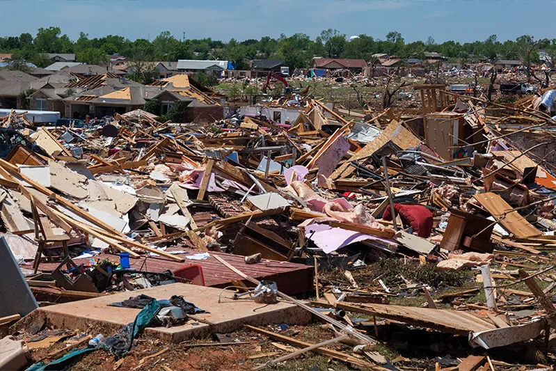Propane Tanks Lined Up in front of debris from a destructive tornado